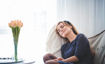 Leisure time at home, young woman relaxing on armchair in bright